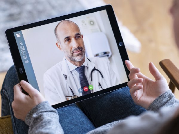 Mujer y niño en videollamada con un médico